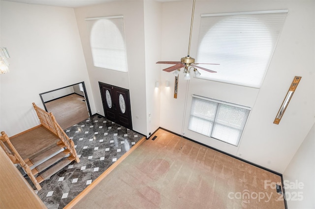 foyer featuring a high ceiling and a ceiling fan