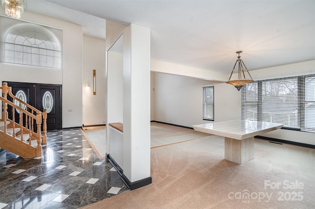 interior space with stairs, visible vents, baseboards, and light colored carpet