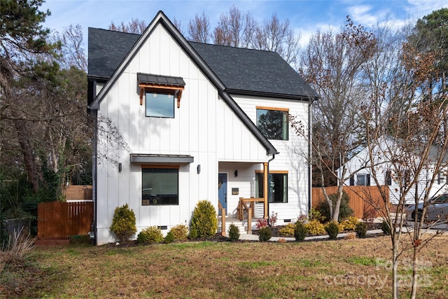 modern inspired farmhouse with fence, roof with shingles, a front lawn, crawl space, and board and batten siding