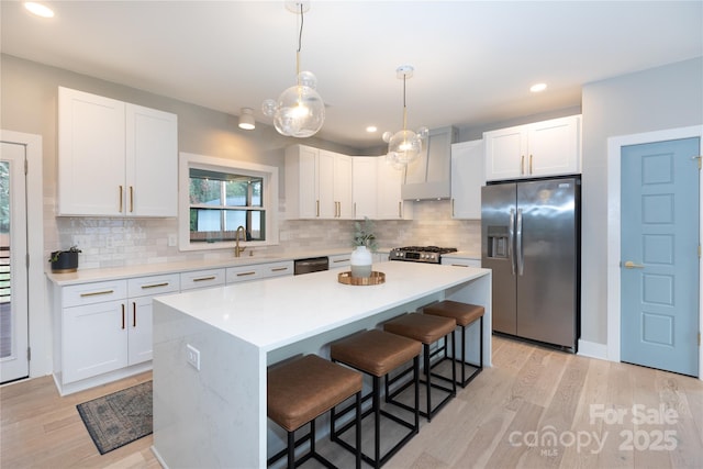 kitchen with a kitchen bar, a sink, a kitchen island, appliances with stainless steel finishes, and custom exhaust hood