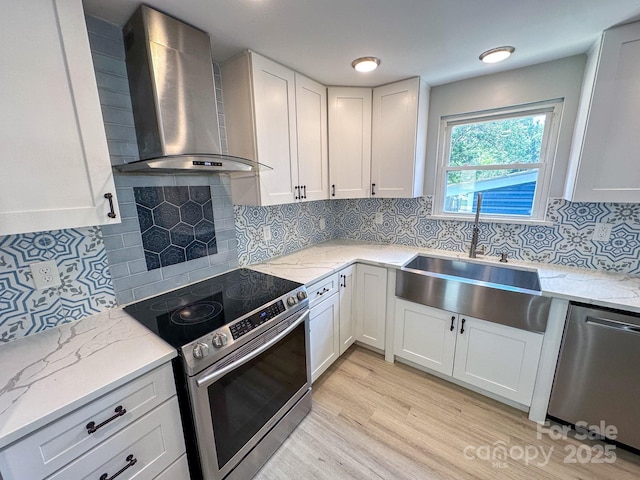 7812 Highbanks Ct, Charlotte, NC 28212 - kitchen featuring wall chimney range hood, light stone countertops, a sink, and appliances with stainless steel finishes