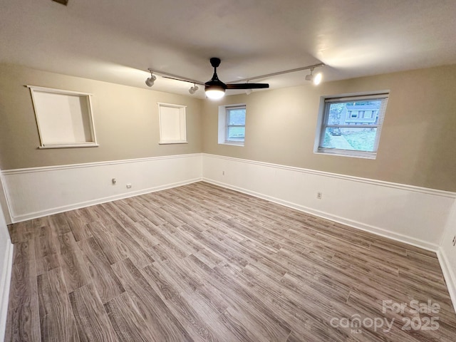 7812 Highbanks Ct, Charlotte, NC 28212 - empty room with baseboards, wood finished floors, track lighting, and a ceiling fan