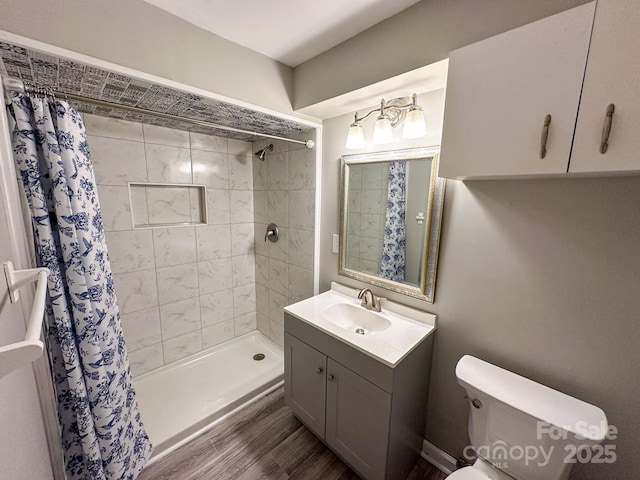 7812 Highbanks Ct, Charlotte, NC 28212 - full bathroom featuring toilet, vanity, a stall shower, and wood finished floors