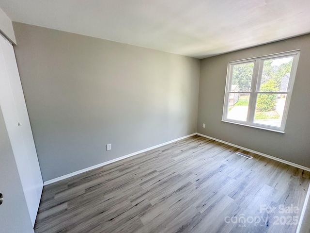 7812 Highbanks Ct, Charlotte, NC 28212 - unfurnished bedroom with baseboards, visible vents, wood finished floors, and a closet