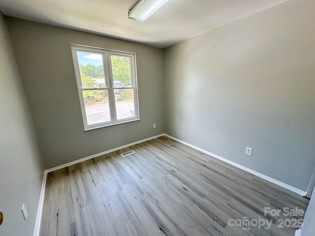 7812 Highbanks Ct, Charlotte, NC 28212 - empty room featuring baseboards, visible vents, and wood finished floors