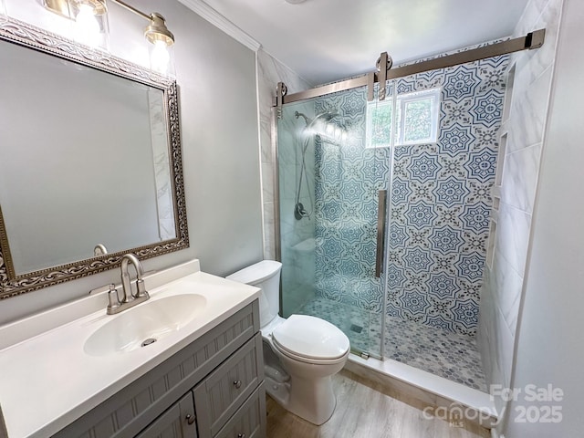 7812 Highbanks Ct, Charlotte, NC 28212 - full bathroom featuring a shower stall, ornamental molding, toilet, wood finished floors, and vanity