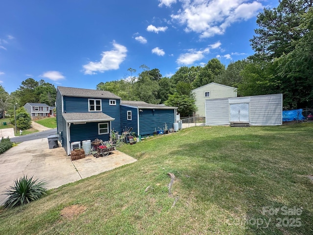 7812 Highbanks Ct, Charlotte, NC 28212 - rear view of house with an outdoor structure, fence, a shingled roof, and a yard