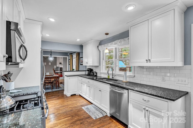 kitchen with white cabinets, appliances with stainless steel finishes, and a sink