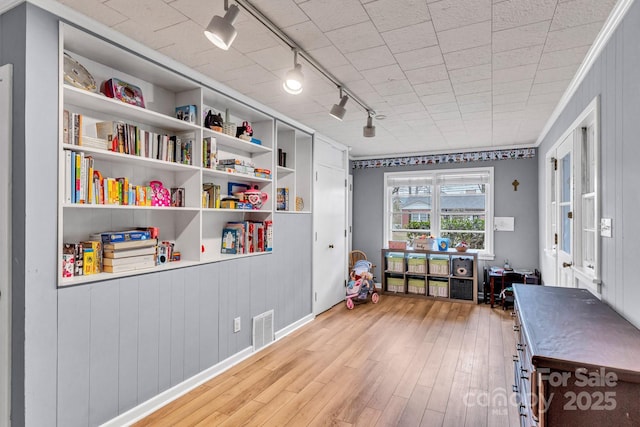 recreation room featuring wood finished floors and visible vents