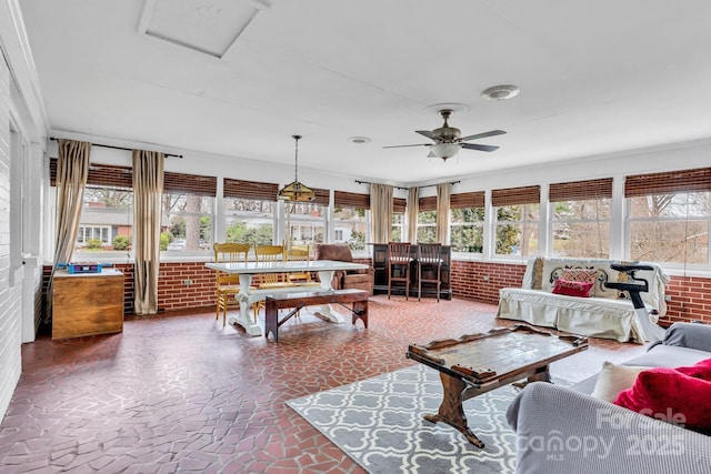 sunroom / solarium featuring ceiling fan