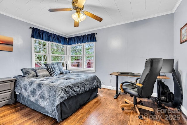 bedroom with baseboards, ceiling fan, crown molding, and hardwood / wood-style flooring