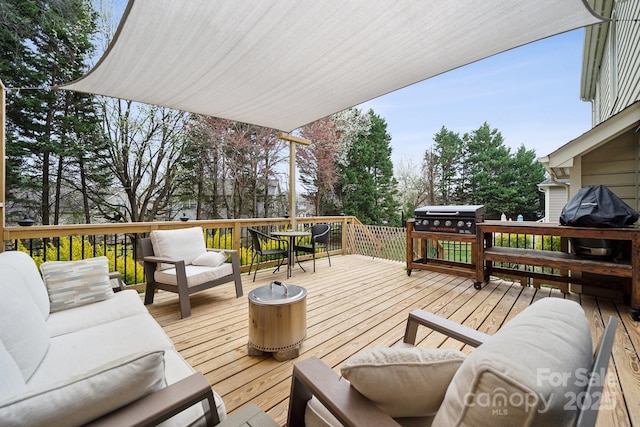 wooden terrace featuring grilling area and outdoor lounge area