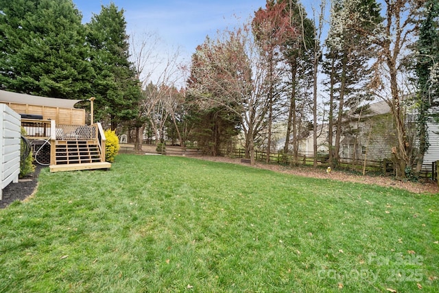 view of yard with a wooden deck and fence