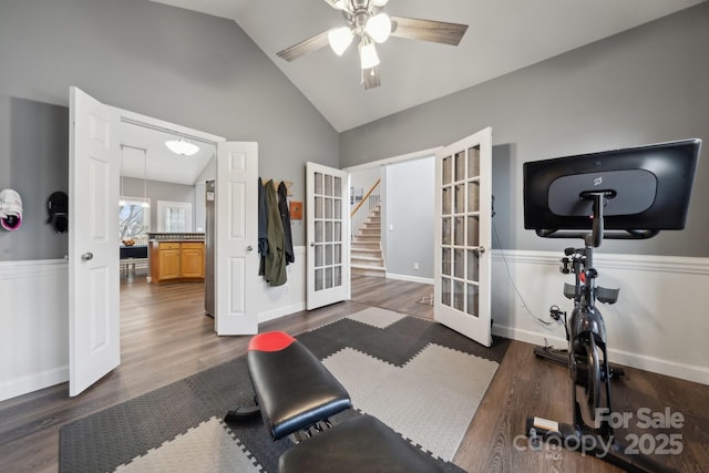 exercise area featuring wood finished floors, baseboards, ceiling fan, vaulted ceiling, and french doors