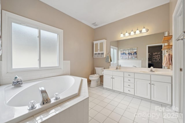 bathroom with a bath, visible vents, double vanity, a sink, and toilet