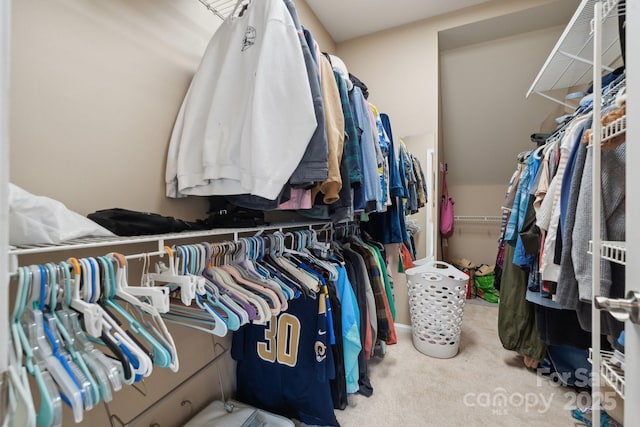 walk in closet with carpet