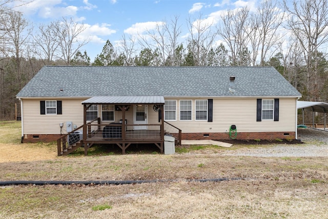 view of front of house featuring crawl space, a detached carport, and roof with shingles