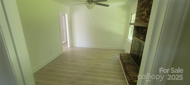 425 Whitethorn Dr, Gastonia, NC 28054 - unfurnished living room featuring a brick fireplace, ceiling fan, and wood finished floors