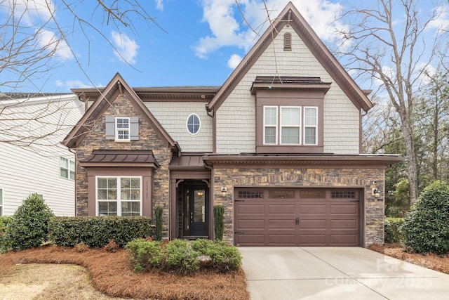 view of front of property with stone siding, driveway, metal roof, and a garage