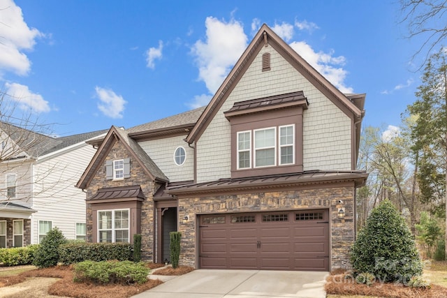 view of front of house featuring a garage, driveway, a standing seam roof, stone siding, and metal roof