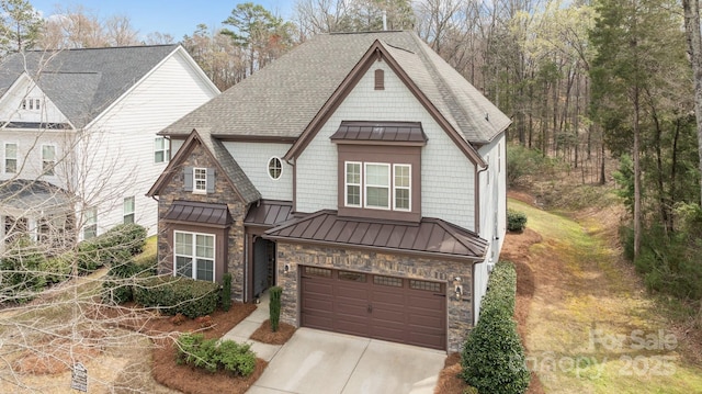 view of front facade featuring stone siding, a garage, metal roof, and a standing seam roof