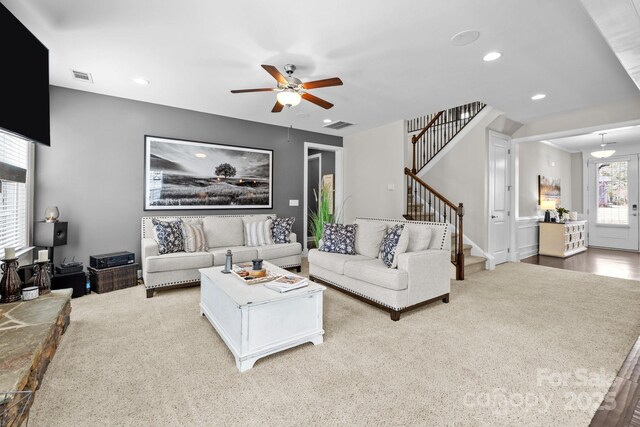 living room with visible vents, recessed lighting, stairs, and a ceiling fan