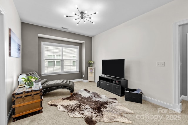 sitting room with carpet flooring, visible vents, baseboards, and a chandelier