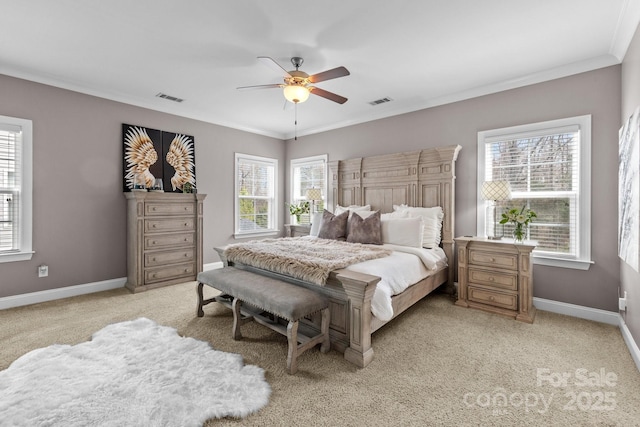 bedroom with visible vents, light colored carpet, baseboards, and ornamental molding