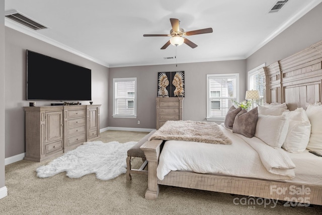 bedroom with multiple windows, visible vents, and ornamental molding