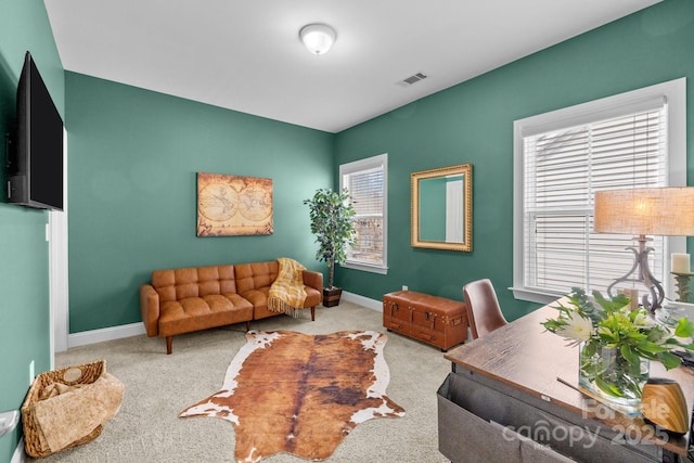 carpeted office featuring baseboards and visible vents