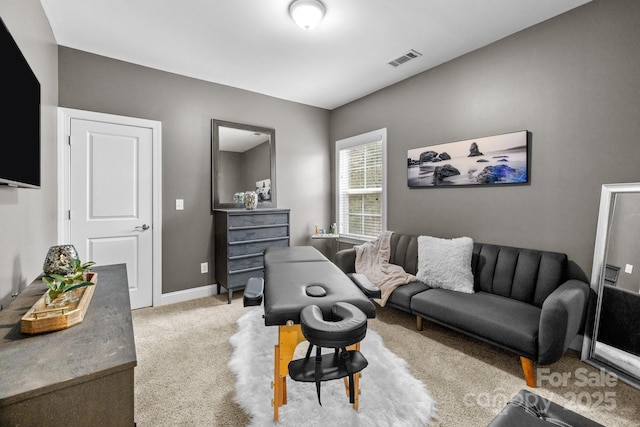 carpeted living room featuring baseboards and visible vents