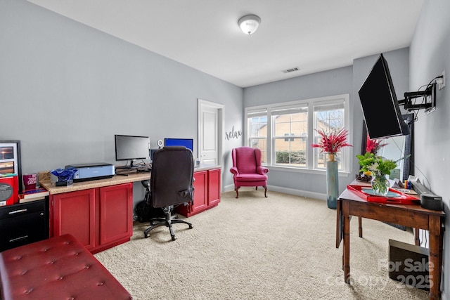 home office featuring visible vents, light colored carpet, and baseboards