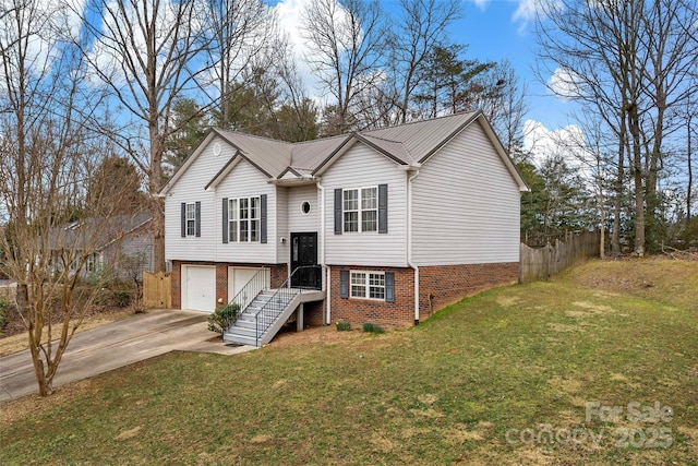 split foyer home with a garage, concrete driveway, a front lawn, and fence