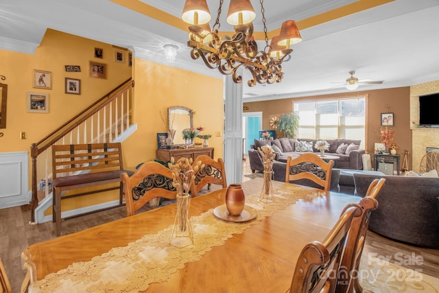 dining space featuring wood finished floors and ornamental molding