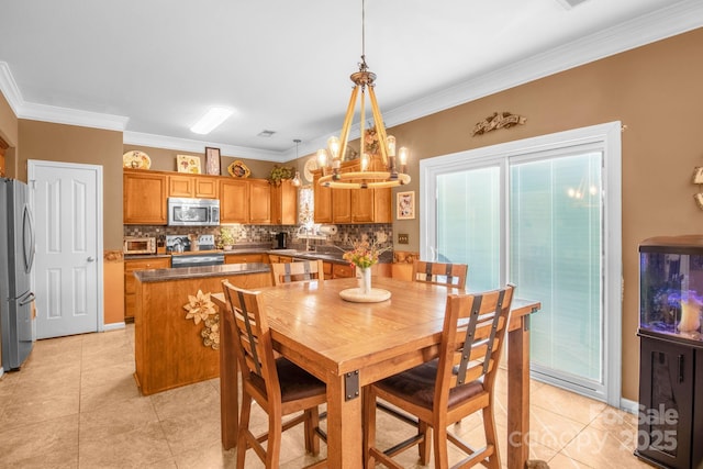 dining space featuring an inviting chandelier, crown molding, and light tile patterned flooring