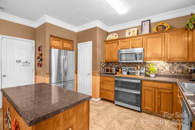 kitchen with tasteful backsplash, brown cabinets, and appliances with stainless steel finishes