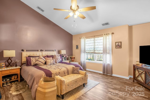 bedroom featuring visible vents, a ceiling fan, baseboards, and wood finished floors