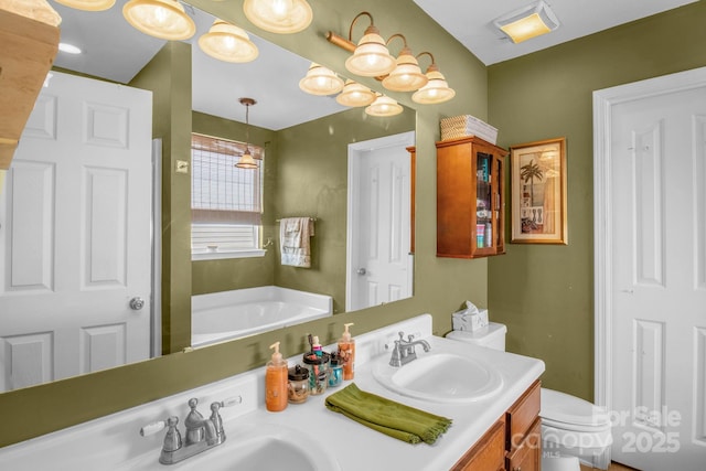 bathroom with double vanity, toilet, visible vents, and a sink