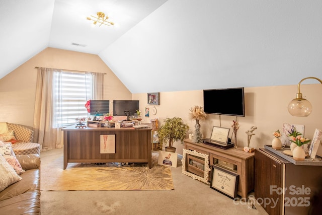 carpeted office space with visible vents and lofted ceiling