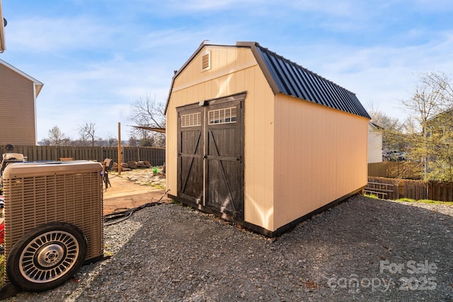 view of shed with central AC unit and a fenced backyard