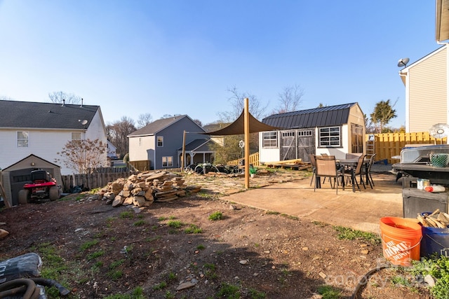 view of yard featuring an outbuilding, a patio area, and a fenced backyard