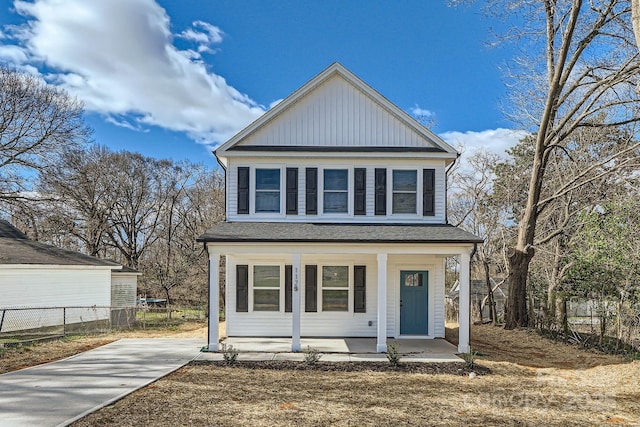 view of front facade featuring covered porch and fence