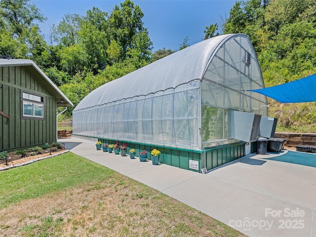 view of greenhouse featuring a yard