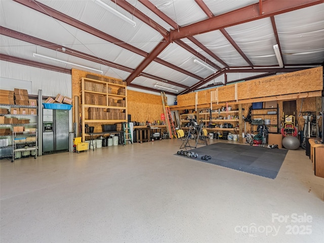 garage with a workshop area and metal wall