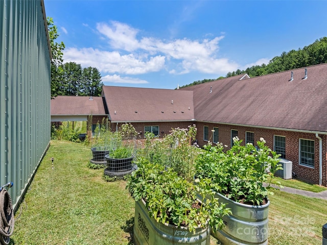 view of yard with cooling unit and a vegetable garden