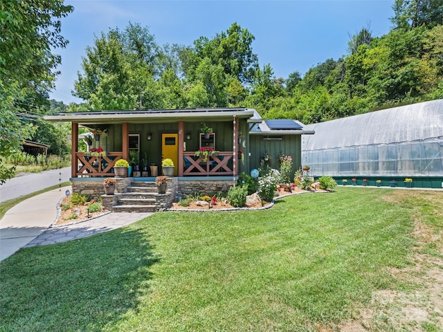 view of front of home featuring board and batten siding, covered porch, and a front lawn