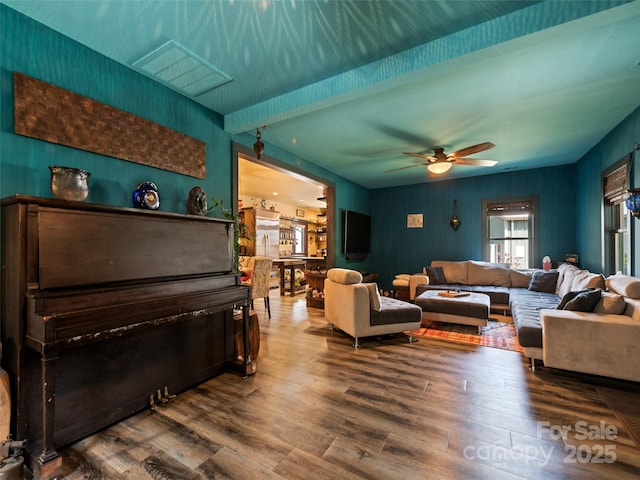 living room with ceiling fan and wood finished floors