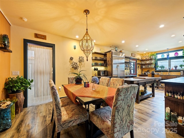 dining space featuring recessed lighting and light wood-style floors