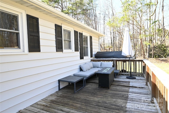 wooden terrace featuring outdoor lounge area