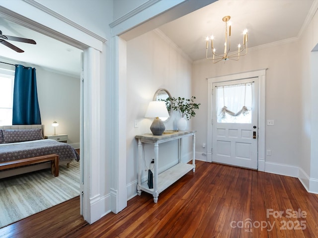 entrance foyer featuring baseboards, a healthy amount of sunlight, ornamental molding, and dark wood-style flooring